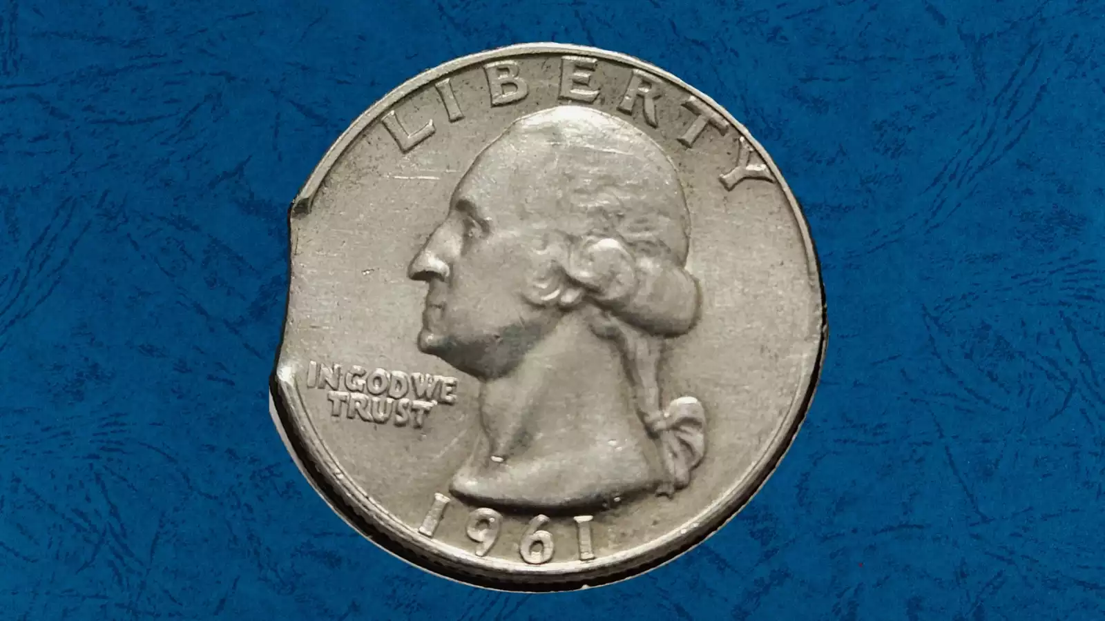 1961 Washington Quarter clipped planchet error showing a curved clip where planchet metal is missing from the coin edge
